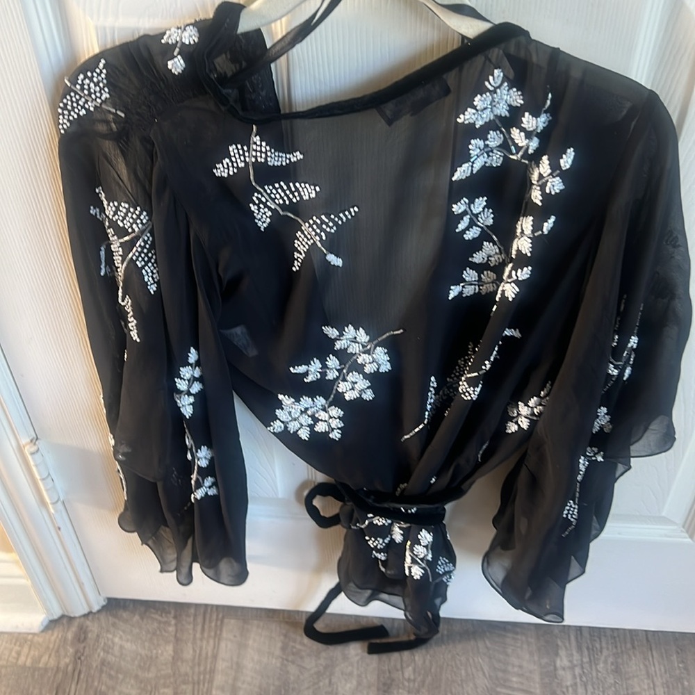 100% silk wrap  size small beaded on both sides and down the arms